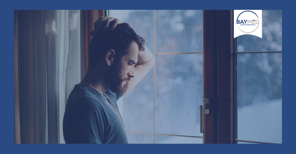 Man staring out his window.